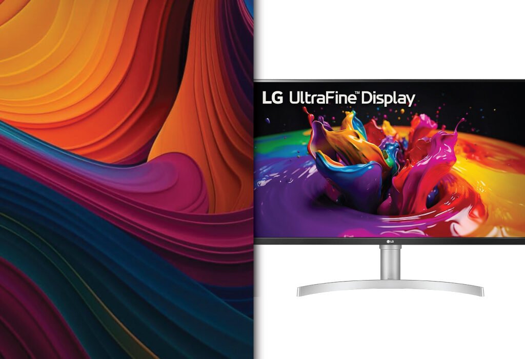 An LG UltraFine Display monitor showing a vibrant, colorful image of paint splashes, with a large, abstract colorful pattern to its left.